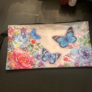 A makeup bag with some eyeshadow and highlighter